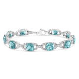 .925 Sterling Silver 7x7 mm Cushion Cut Blue Topaz and 1/20 cttw Round Cut Diamond Fashion Tennis Bracelet (I-J Color, I1-I2 Clarity) - 7"